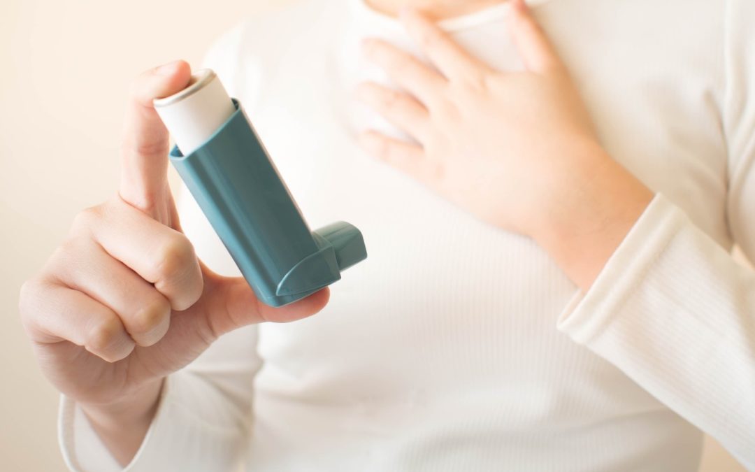 person holding an inhaler